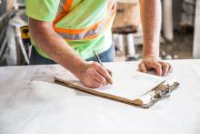 Stock photo of worker with clipboard